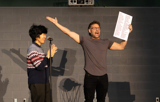 Eric Leclerc and a student volunteer on stage