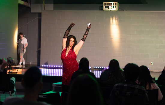 Remedy performs in a floor length red gown