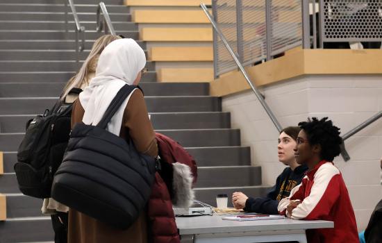 Club members speaks with a student