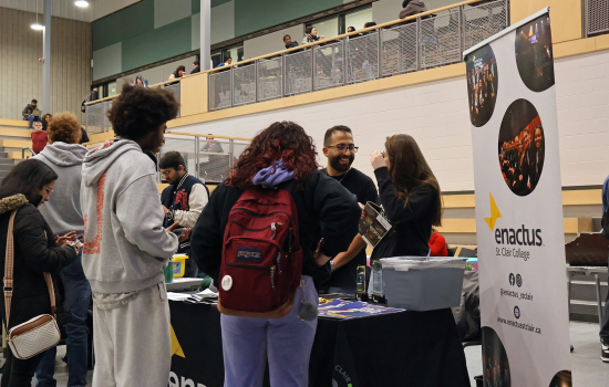 Club members speak with students