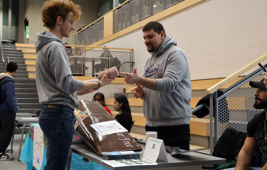 Club members speaks with a student