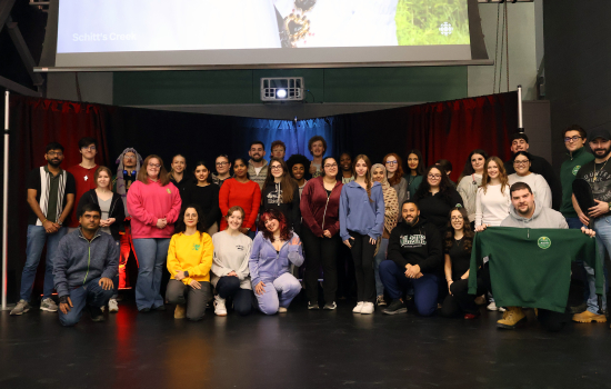 All club members and SRC board members pose for a group photo on the SLC stage