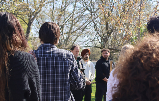 Students and staff gather to watch the tree planting ceremony