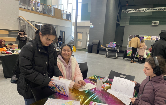 3 students enjoy the colouring station