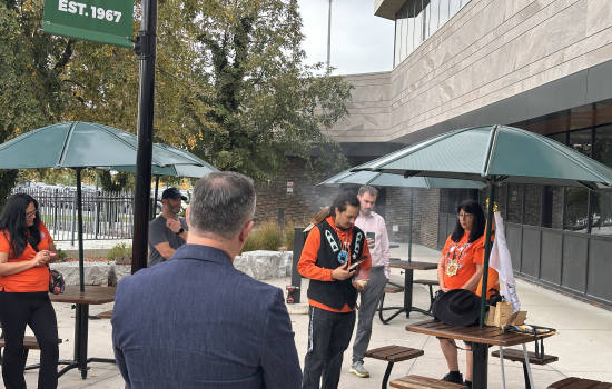 Smudging ceremony by the front entrance of St. Clair College