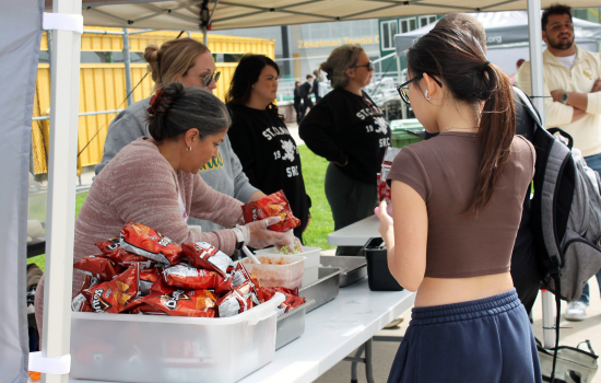 Students line up as SRC staff give out walking tacos