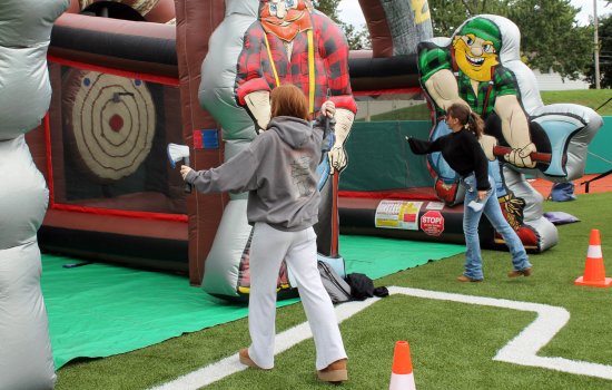 2 students playing inflatable ax throwing