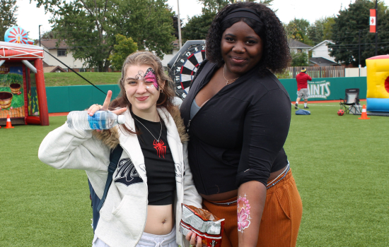 Students show off their face paint and airbrush tattoos