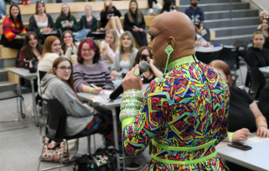 Drag Queen Sabin addresses a group of students during Dirty Bingo