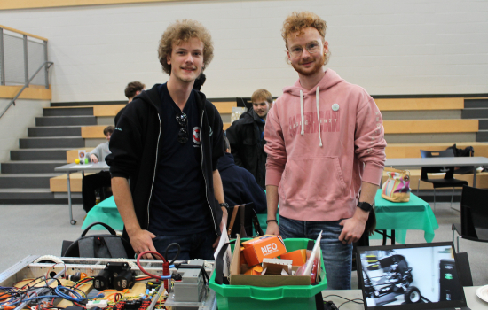 Robotics Club members at their booth in the SLC