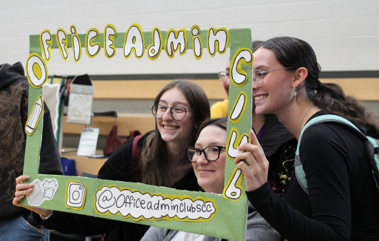 Students posting a DIY Office Admin Club frame