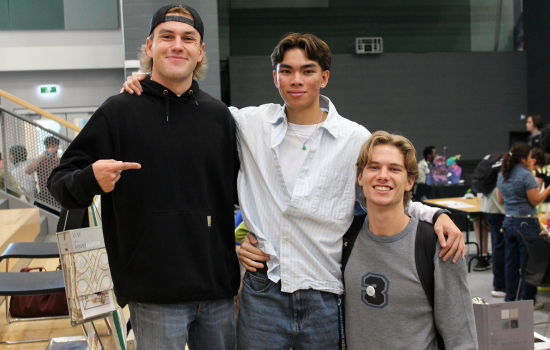 3 students smile for the camera at the Clubs Fair