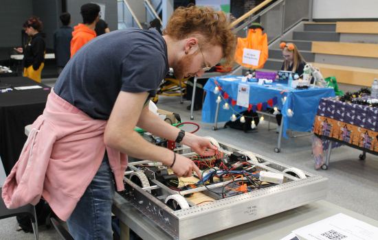 Robotic Club member at their booth in the SLC