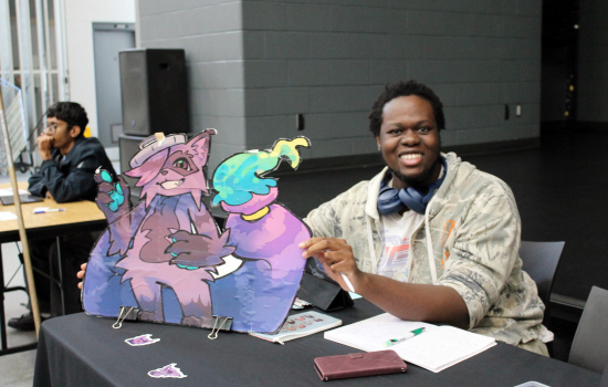 Animation Club member at their booth in the SLC