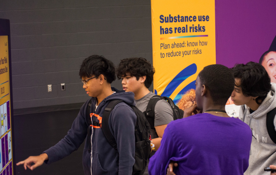 Students engage with a digital screen at the Reduce Your Risk event