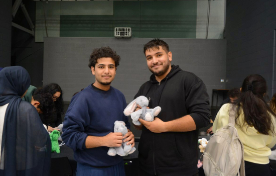 Two students pose with their cuddly bunnies