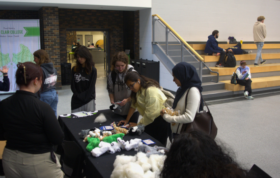 Students gather at a table covered in fluff in the SLC
