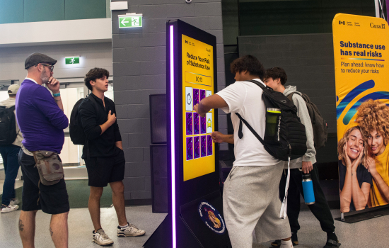 Students engage with a digital screen at the Reduce Your Risk event