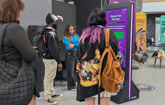 Students engage with a digital screen at the Reduce Your Risk event